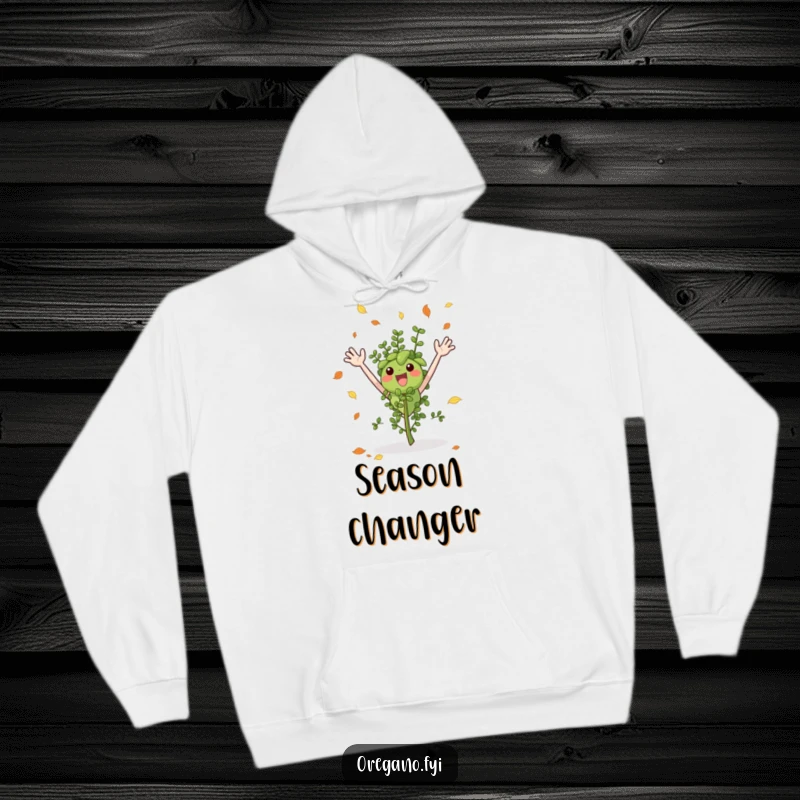 Funny hoodie depicting an excited oregano sprig, arms waving, happily catching falling leaves in a colorful autumn scene.